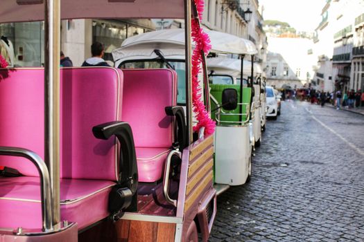 Colorful Tuk Tuks parked in a Lisbon street in Spring