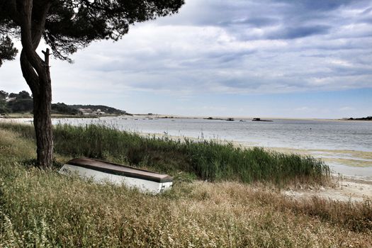 Boats on Lagoa de Albufeira on a cloudy day in Spring