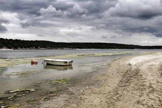 Boats on Lagoa de Albufeira on a cloudy day in Spring