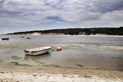 Boats on Lagoa de Albufeira on a cloudy day in Spring
