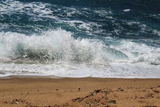 Crystal clear and wild waters in Praia da Foz, Sesimbra, Portugal. Golden sand , seagulls flying, Cliffs and rock formation