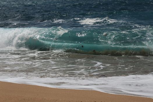 Crystal clear and wild waters in Praia da Foz, Sesimbra, Portugal. Golden sand , seagulls flying, Cliffs and rock formation