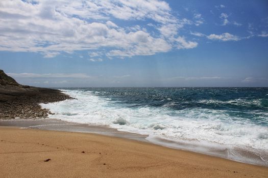 Crystal clear and wild waters in Praia da Foz, Sesimbra, Portugal. Golden sand , seagulls flying, Cliffs and rock formation