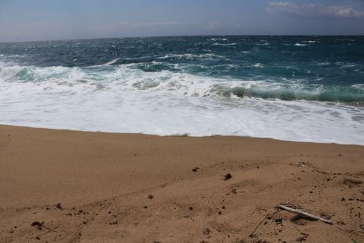 Crystal clear and wild waters in Praia da Foz, Sesimbra, Portugal. Golden sand , seagulls flying, Cliffs and rock formation