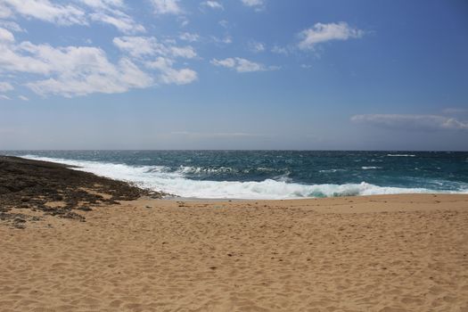 Crystal clear and wild waters in Praia da Foz, Sesimbra, Portugal. Golden sand , seagulls flying, Cliffs and rock formation