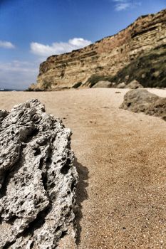 Crystal clear and wild waters in Praia da Foz, Sesimbra, Portugal. Golden sand , seagulls flying, Cliffs and rock formation