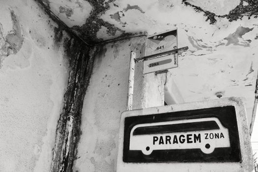 Lisbon, Portugal- May 29, 2018: Damaged and vintage Bus stop in Lisbon city. Word stop on the sign. Monochrome Photography.