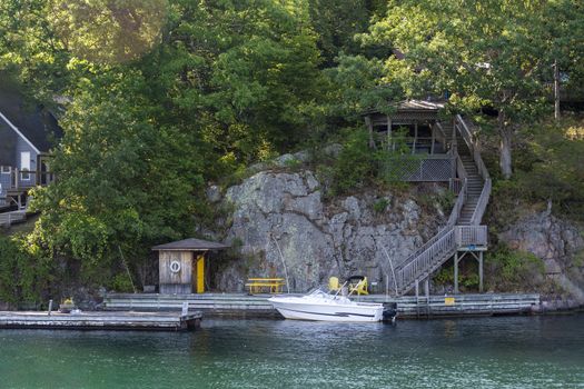 A wooden gazebo built on a cliff above the pier leads to it by a long steep staircase