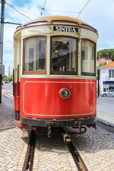 Colorful red tram through the streets of Sintra, Lisbon in Spring.