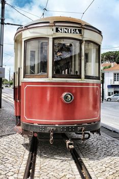 Colorful red tram through the streets of Sintra, Lisbon in Spring.