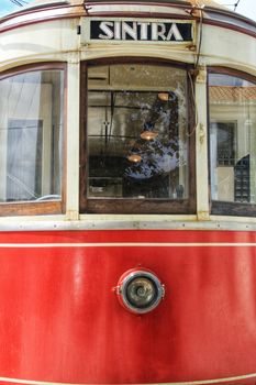 Colorful red tram through the streets of Sintra, Lisbon in Spring.