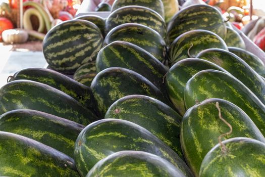 Side angle view of rows of Watermelons in the Farmers Market . High quality photo