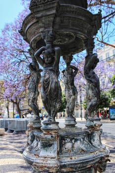 Beautiful stone fountain at Rossio Square in Lisbon, Portugal