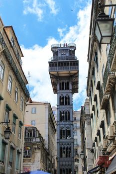 Lisbon, Portugal- May 30, 2018: Santa Justa Lift in Lisbon and majestic building facades under blue sky, Portugal.