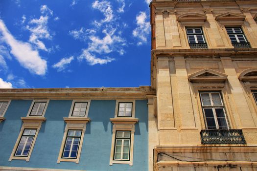 Old colorful and majestic tiled facades with vintage streetlight in Lisbon streets in Spring.