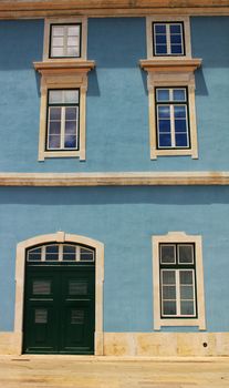 Old colorful and majestic tiled facades with vintage streetlight in Lisbon streets in Spring.