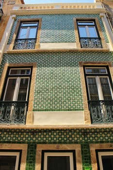 Old colorful houses and streets of Lisbon, Portugal in Spring. Majestic facades and old street lights.