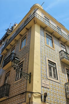 Old colorful houses and streets of Lisbon, Portugal in Spring. Majestic facades and old street lights.