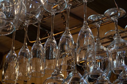 Wine glasses hang upside down. Perfectly clean glass