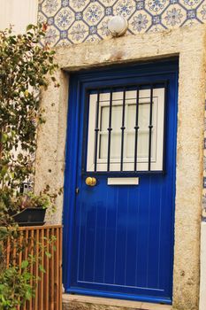 Old and colorful wooden door with iron details in Lisbon, Portugal