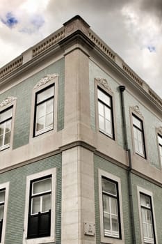 Old colorful and majestic tiled facades with vintage streetlight in Lisbon streets in Spring.