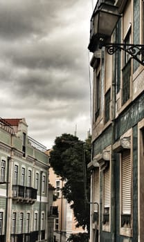 Old colorful houses and streets of Lisbon, Portugal in Spring. Majestic facades and old street lights.