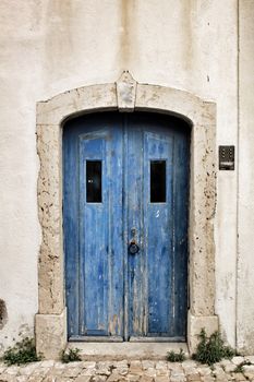 Old and colorful wooden door with iron details in Lisbon, Portugal