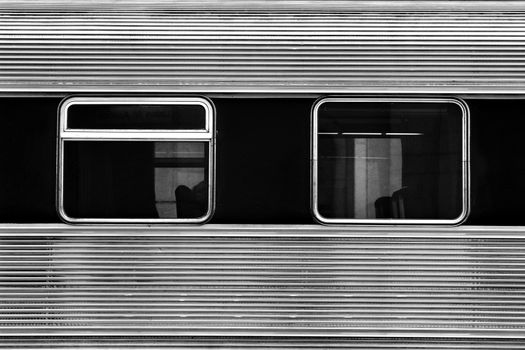 Train carriage windows. Metallic texture monochrome photography.