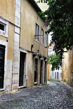 Lisbon, Portugal- June 3, 2018:Old colorful houses and narrow streets of Lisbon, Portugal in Spring. Majestic facades and old street lights.