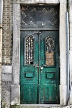 Old and colorful wooden door with iron details in Lisbon, Portugal