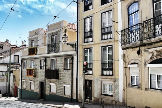 Lisbon, Portugal- June 2, 2018:Old colorful houses and narrow streets of Lisbon, Portugal in Spring. Majestic facades and old street lights.