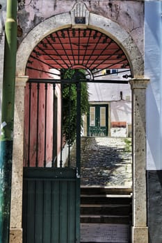 Old colorful houses and narrow streets of Lisbon, Portugal in Spring. Majestic facades and old street lights.