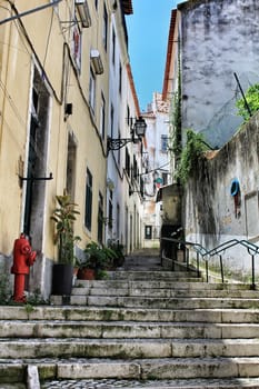 Old colorful houses and narrow streets of Lisbon, Portugal in Spring. Majestic facades and old street lights.