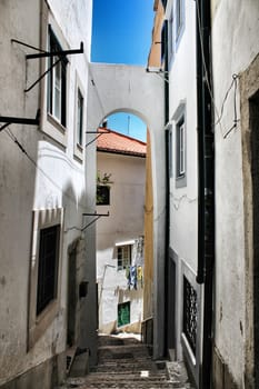 Lisbon, Portugal- June 3, 2018: Old colorful houses and narrow streets of Lisbon, Portugal in Spring. Majestic facades and old street lights.