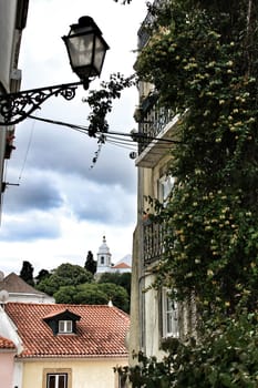 Old colorful houses and streets of Lisbon, Portugal in Spring. Majestic facades and old street lights.