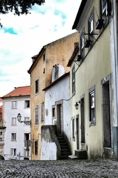 Old colorful houses and streets of Lisbon, Portugal in Spring. Majestic facades and old street lights.