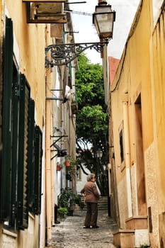 Lisbon, Portugal- June 10, 2018: Old colorful houses and narrow streets of Lisbon, Portugal in Spring. Majestic facades and old street lights.