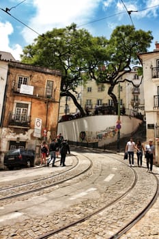 Lisbon, Portugal- June 10, 2018: Old colorful houses and narrow streets of Lisbon, Portugal in Spring. Majestic facades and old street lights.