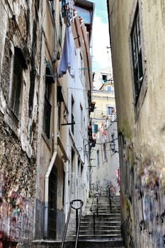 Lisbon, Portugal- June 10, 2018: Old colorful houses and narrow streets of Lisbon, Portugal in Spring. Majestic facades and old street lights.