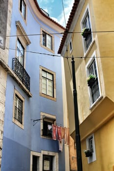 Old colorful houses and streets of Lisbon, Portugal in Spring. Majestic facades and old street lights.