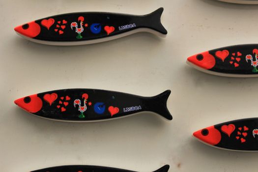 Fridge souvenir magnets imitating portuguese sardines for sale. Word Lisbon written on them.