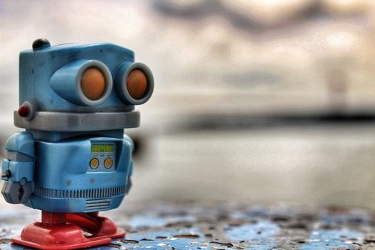 Toy robot on the banks of the Tagus River in Lisbon in a Cloudy day