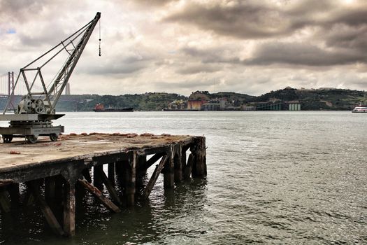 Old crane and dock on the shore of The Tagus River