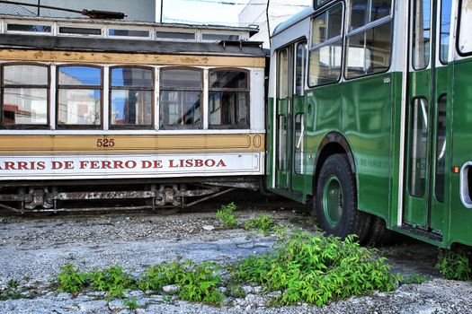 Lisbon, Portugal- June 15, 2018: Old and colorful passenger bus and vintage tram in a museum.
