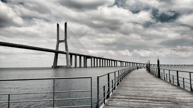 Vasco da Gama Bridge under cloudy sky in Lisbon, Portugal