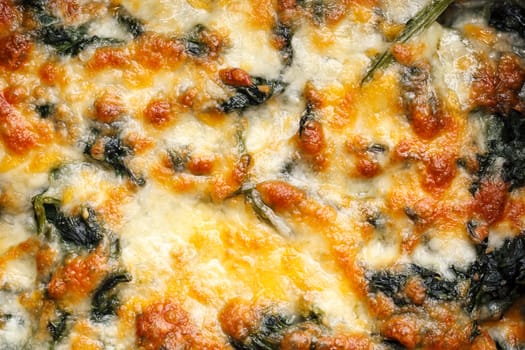 close up of homemade baked spinach with cheese, healthy gourmet food recipe, good work from home lunch idea