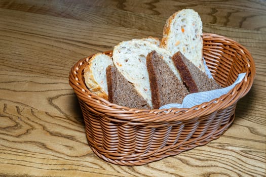 Black and white bread in a basket. Sliced ??bread in a basket. Pieces of bread are ready to eat