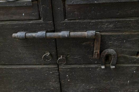 vintage latch on a historic door with signs of rust