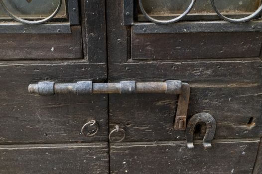 vintage latch on a historic door with signs of rust
