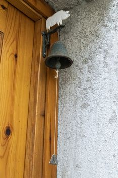 vintage bell hanging on a door to ring